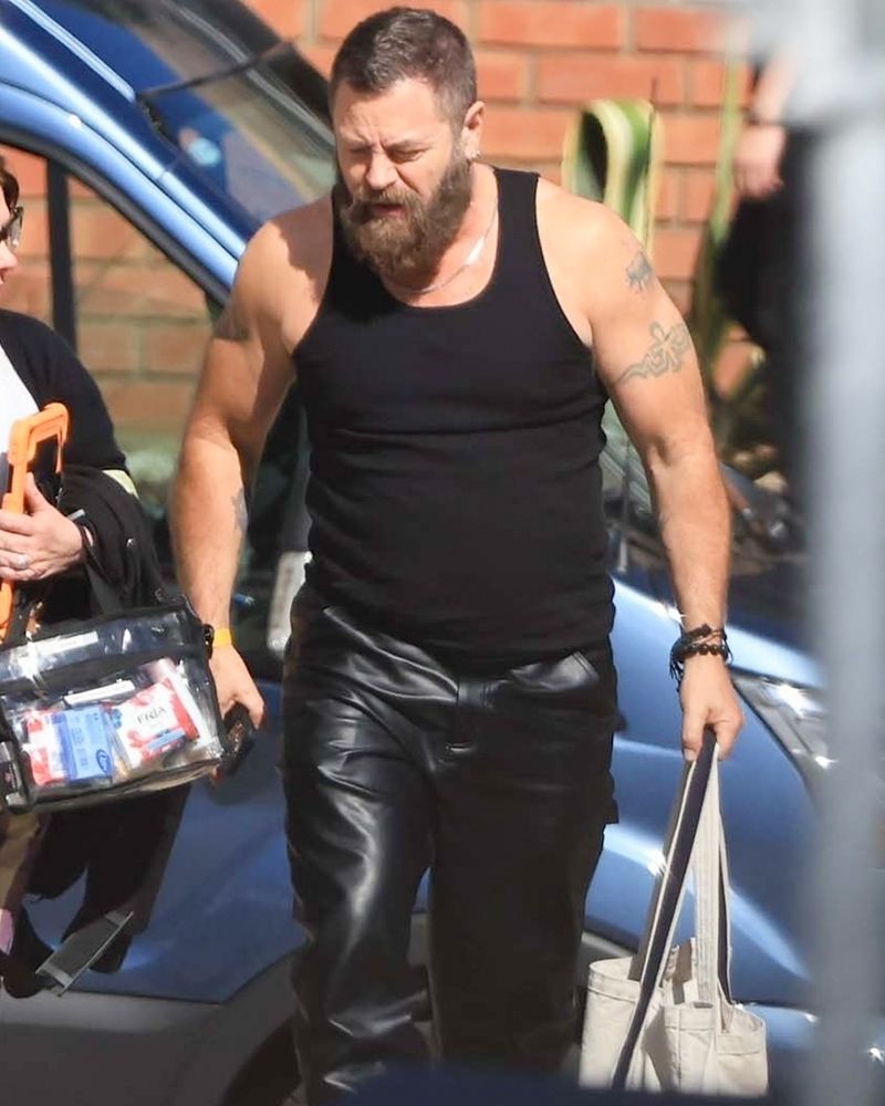 Nick Offerman wearing black leather pants and a black tank top 