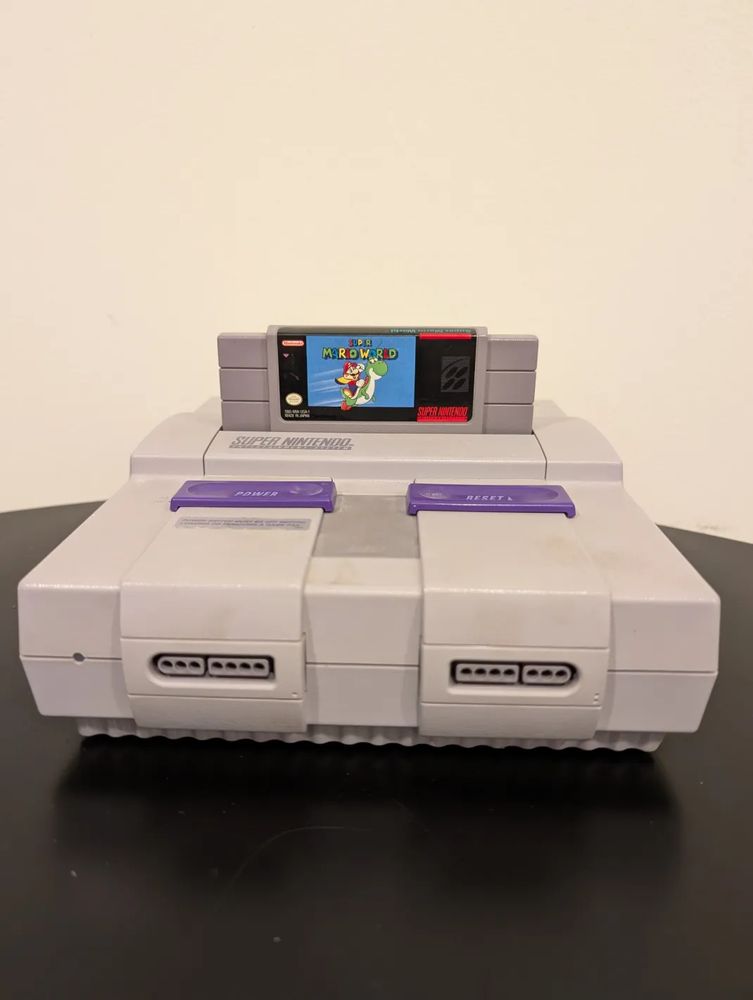 A Super Nintendo Entertainment System with a Super Mario World cartridge inserted.