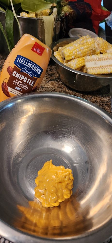 I was making corn ribs, so I'm using Chipotle mayo Two metal bowls, one with a squeeze of the mayo in it and one with the awaiting corn ribs They're tough to make, just in the cutting up but incredible way to cook fresh corn on the cob 