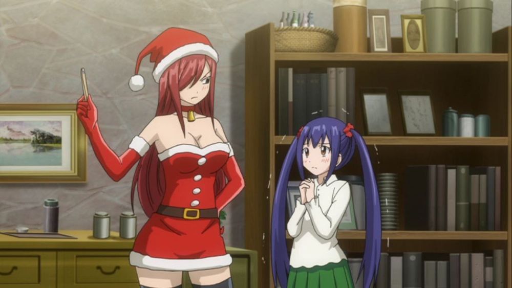Erza Scarlet in Santa Claus clothes holding up a match, apparently lecturing Wendy Marvell.
