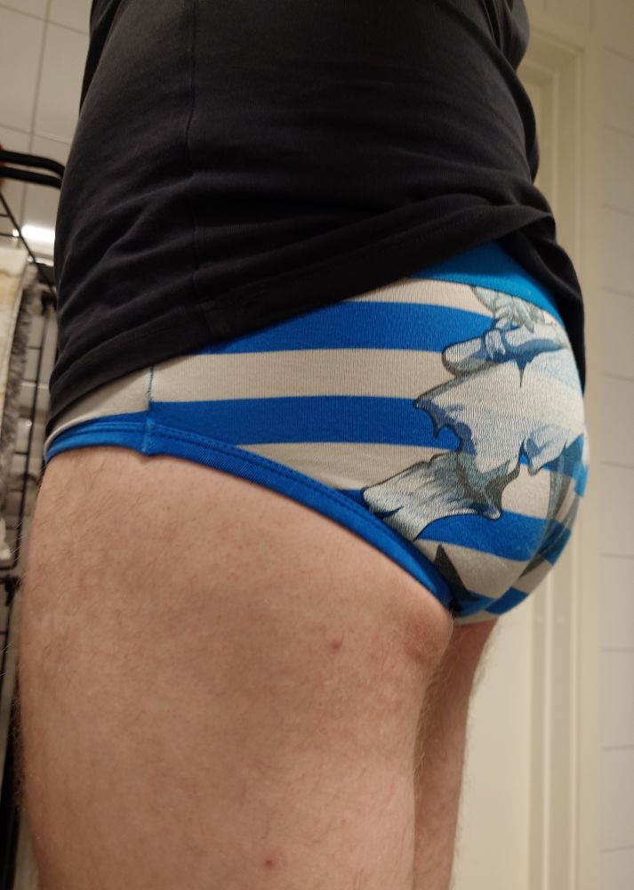 My buns in blue and white striped briefs with a faded sailor's tattoo on the back