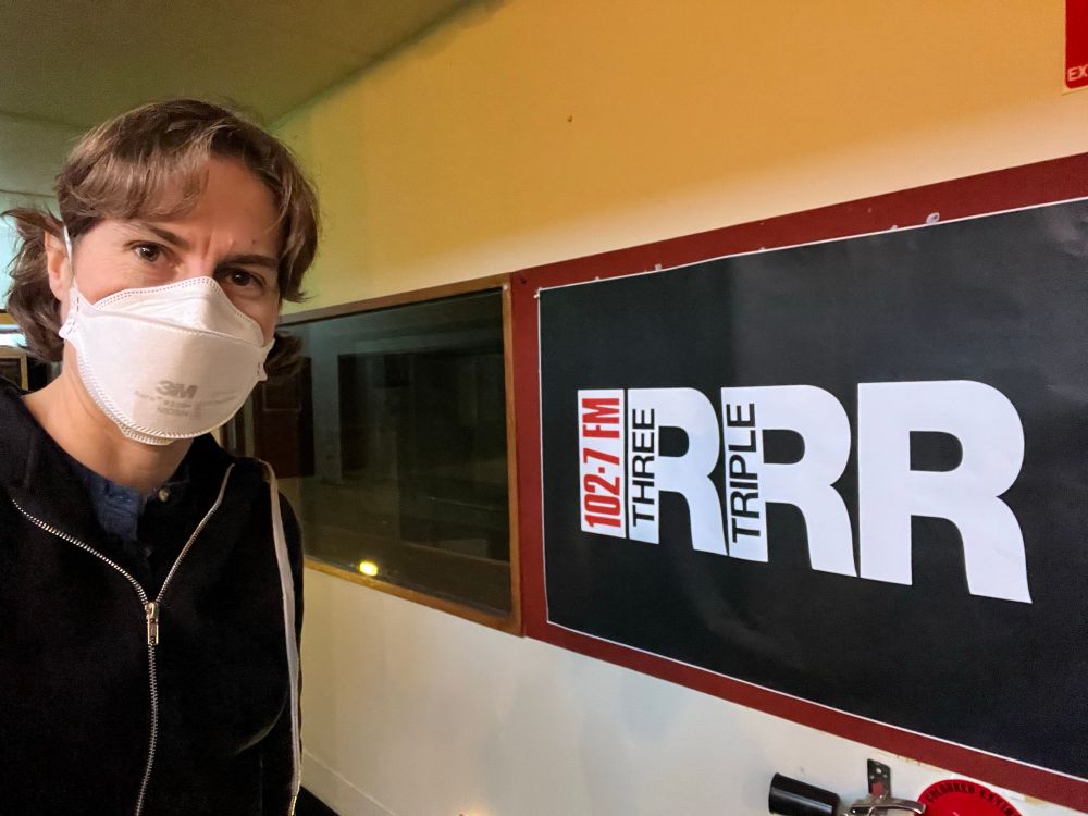 Me wearing an N95 mask standing in front of a sign with the RRR logo inside the recording studio building 