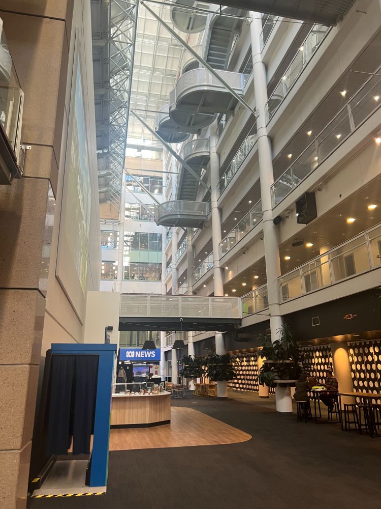 A view of the interior of the Australian Broadcasting Corporation building in Ultimo. A tall airy atrium with balconies and lots of light.