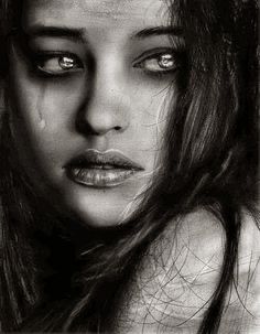 Image in black and white of a young woman crying. 