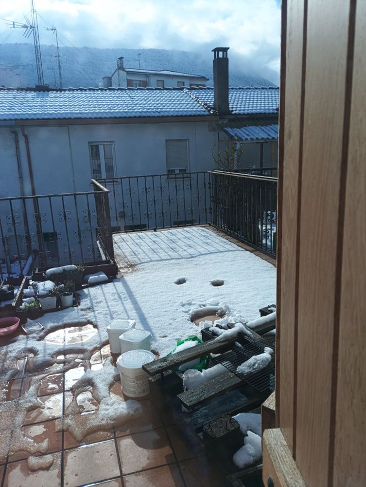 Terraza llena de nieve, excepto dos círculos pequeños en medio y uno grande un poco más abajo 