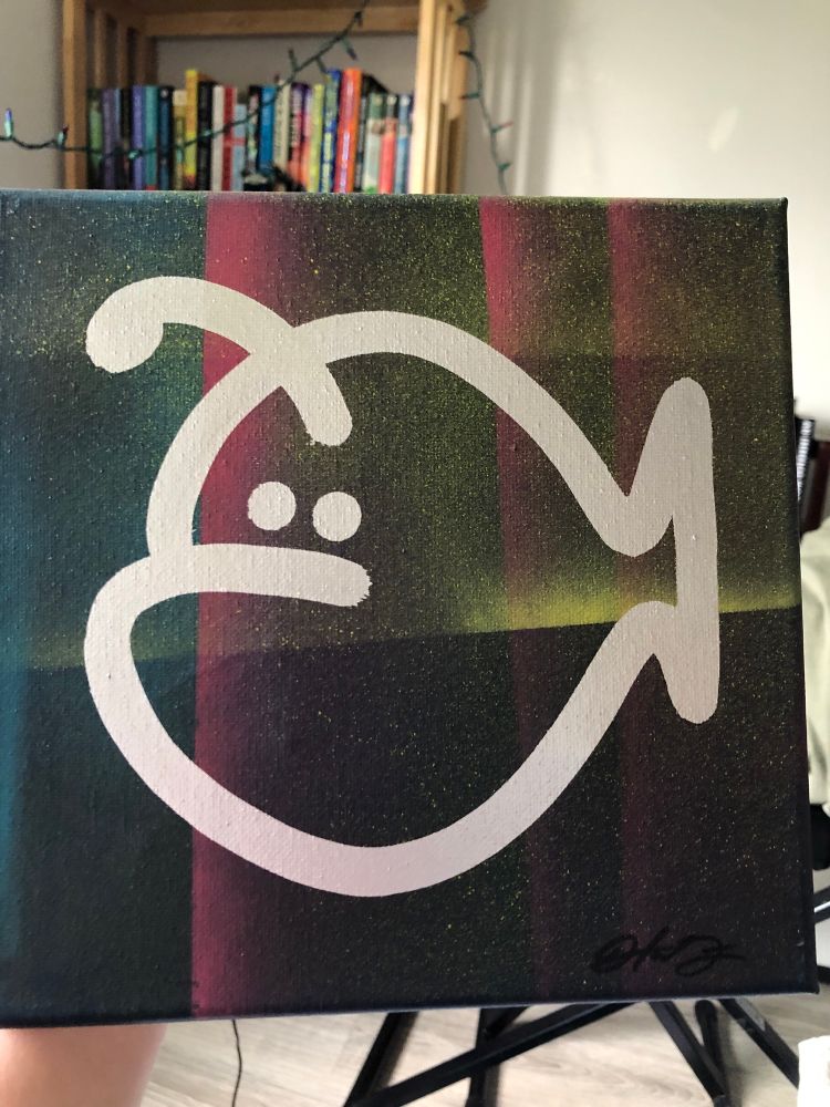 A canvas painting of a Hanklerfish. The background is black with wispy stripes of blue, pink, and orange. It looks like a desert night with neon beams lighting up the sky. A bold Hanklerfish is painted in silver. 