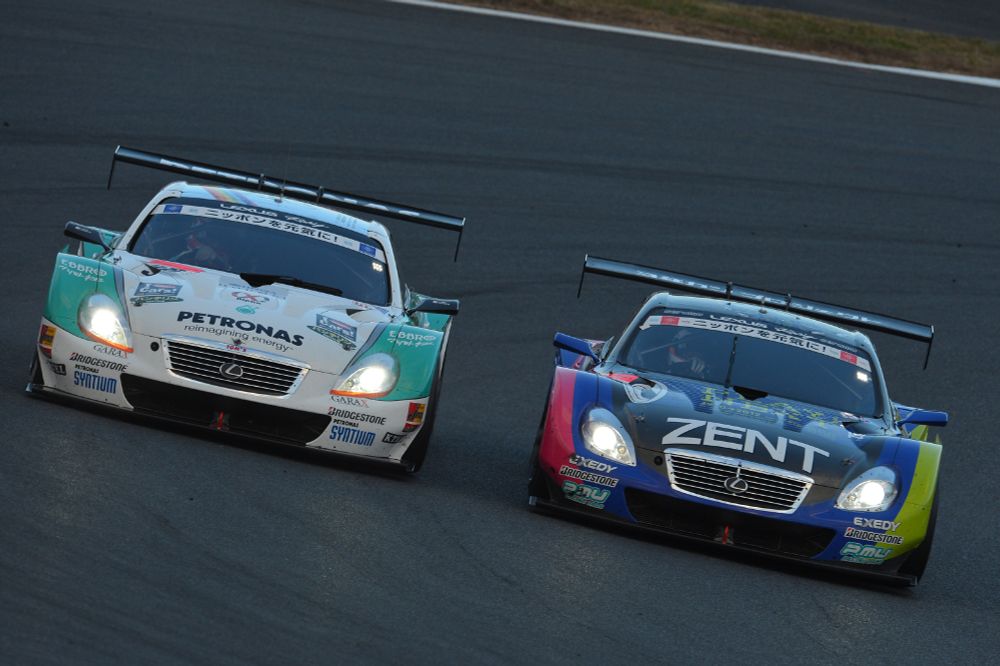 Two GT500 spec Lexus SC 430s race side-by-side at Fuji Speedway during the 2012 SUPER GT Fuji Sprint Cup