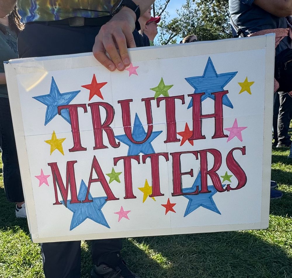 scene from the No Kings rally on Boston Common. photo shows a close up of a poster that reads "TRUTH MATTERS"--beautifully hand-stenciled superimposed on many colorful stars