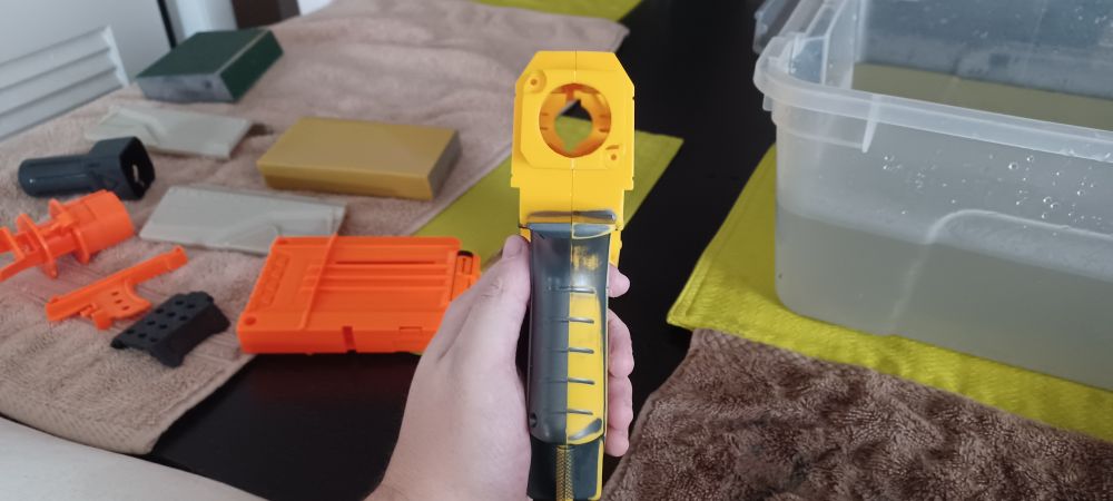 a photo showing the back of the Nerf N-Strike Recon CS-6 base, one side left untouched, with the other side showing visible signs of paint wear