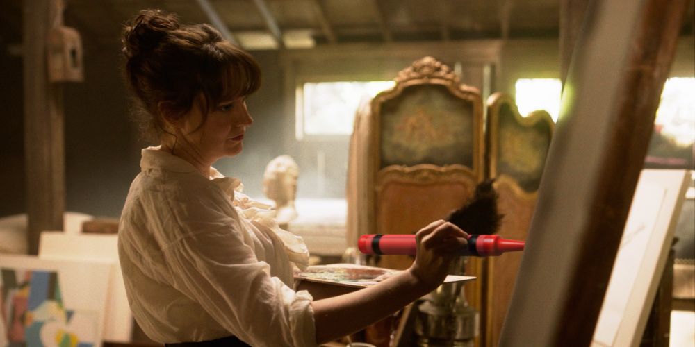 A screenshot of Mary Allamby Bonnet living her best life, coloring with a superimposed crayon on a canvas in her studio 