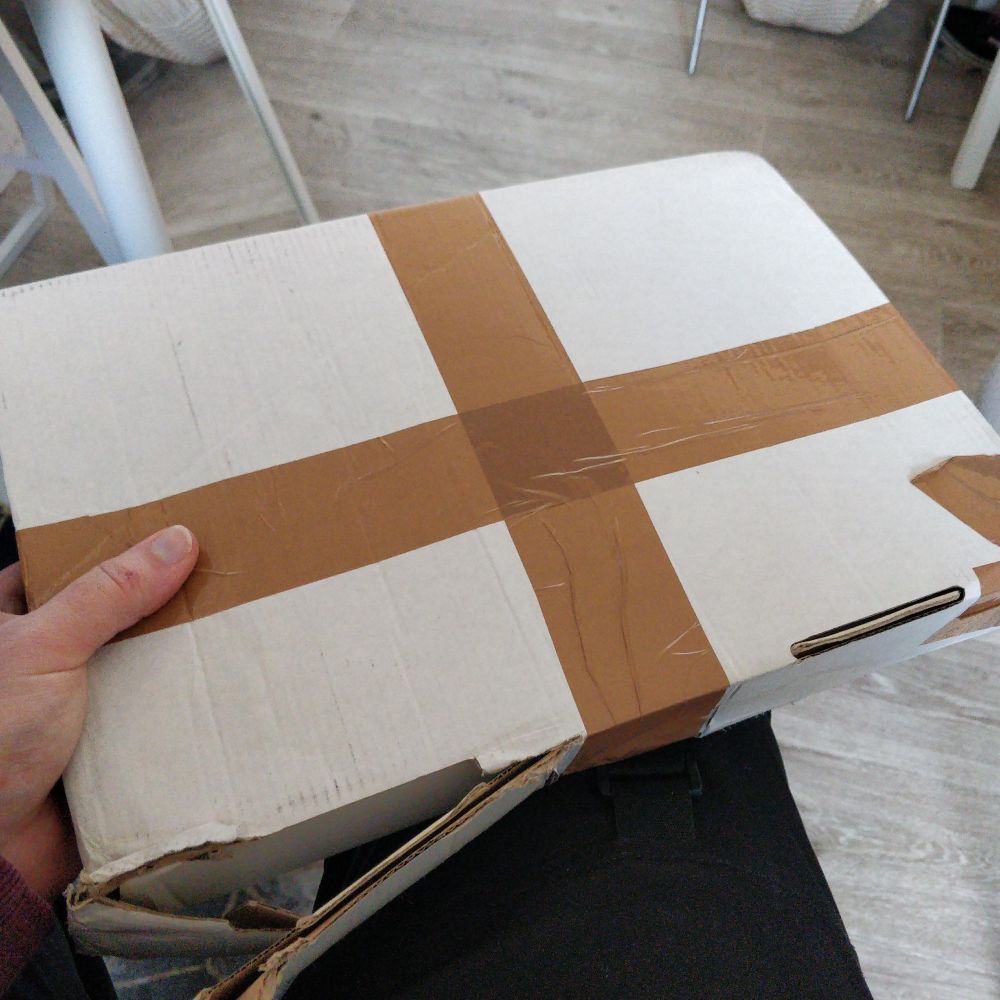 I have a white carboard box sealed with packaging tape