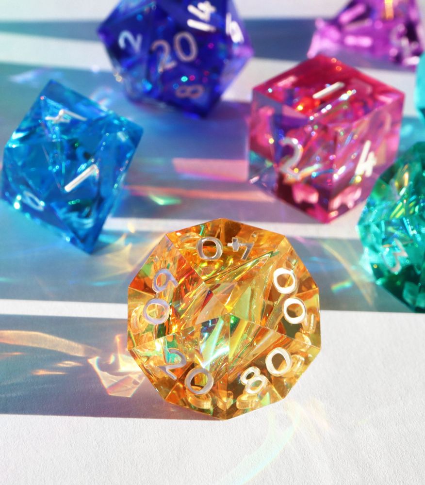 Closeup of the yellow D100 with other dice sitting in the background.