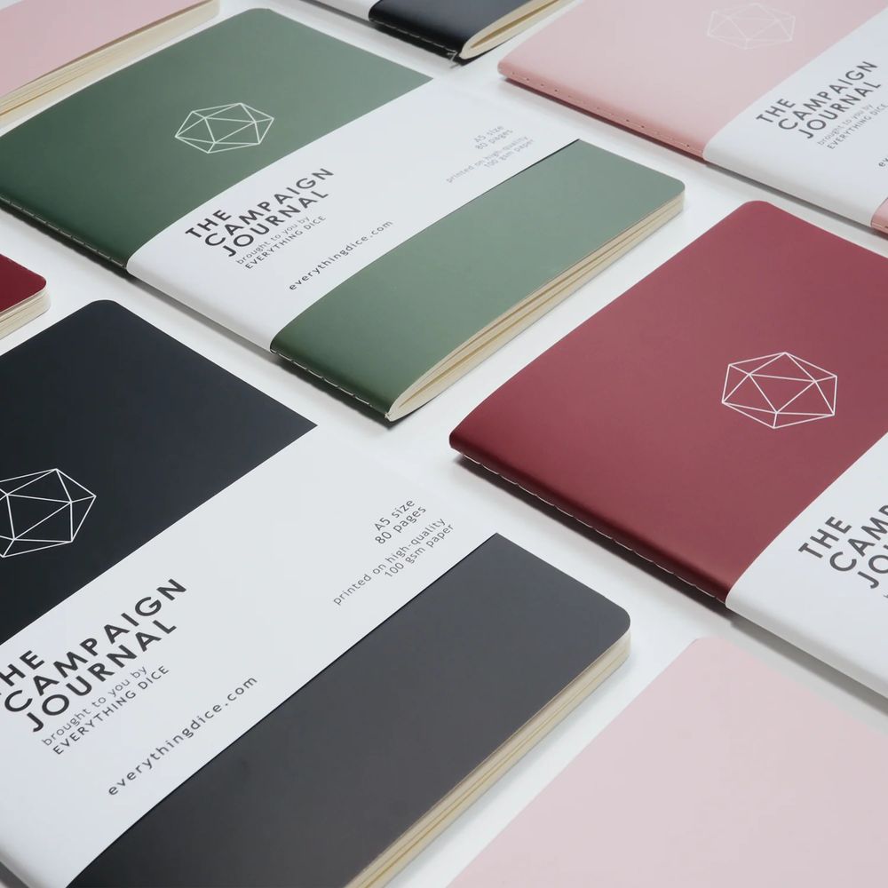 Softcover campaign notebooks aligned in a grid with colors of black, green, maroon, and pink.