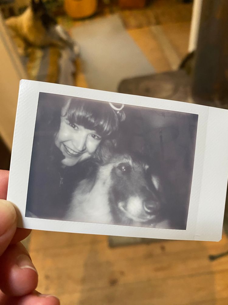 Kim smiling with Malia’s dog, Mae