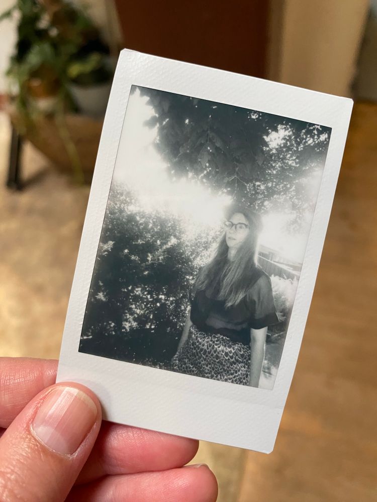 Malia standing outside with the sun behind her