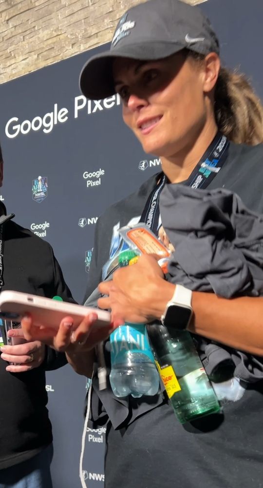 Katie Stengel literally has her hands full with a water bottle, a topo Chico, at least one shirt, a cell phone and a cord of some sort