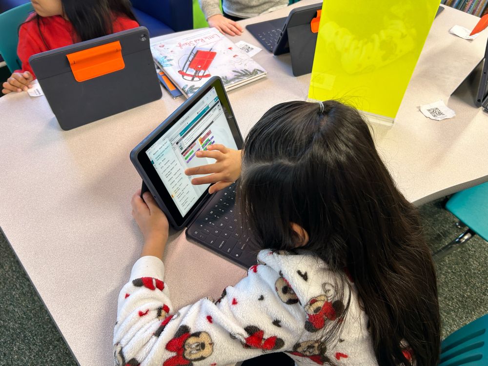 A student coding on an iPad