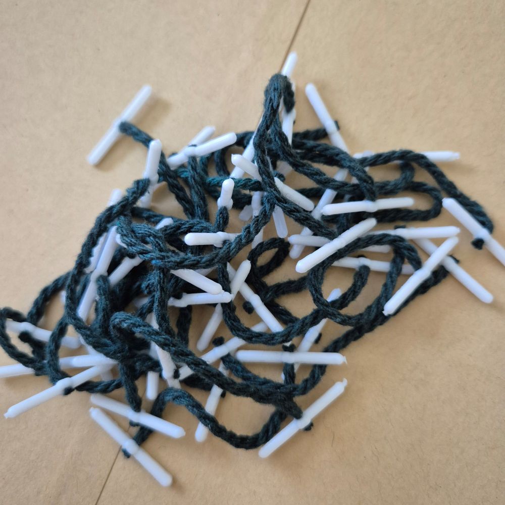A clump of those little stringy things we use to fasten exam script books together.