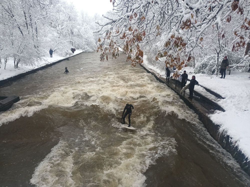 Clip of snow surfers on the river. The banks are covered in a thick layer of snow