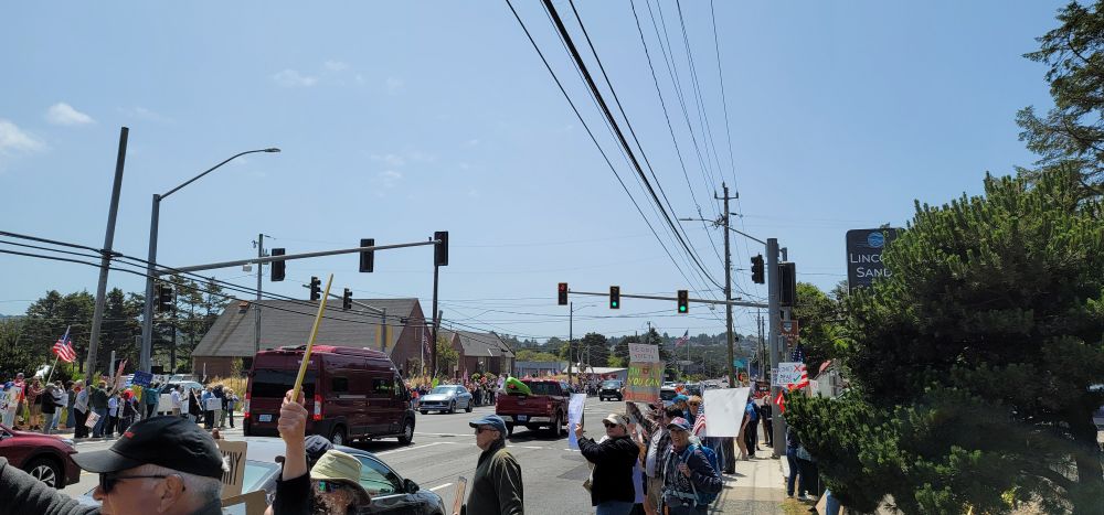 Several pictures of the No Kings protest in Lincoln City Oregon with at least a few hundred attendees carrying various signs opposing Donald Trump.