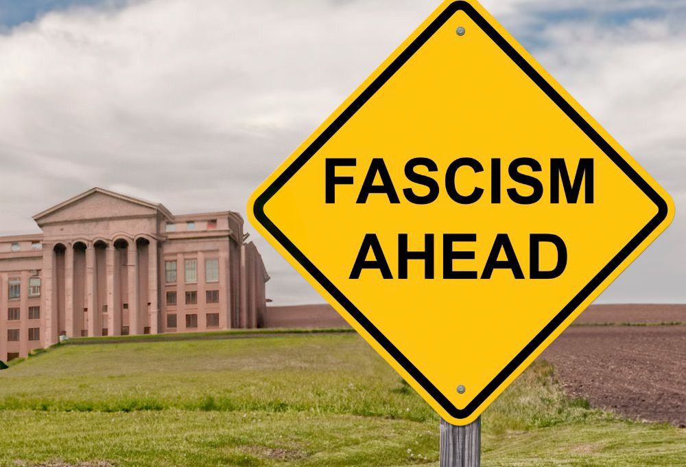 University building with warning sign in foreground: “fascism ahead”