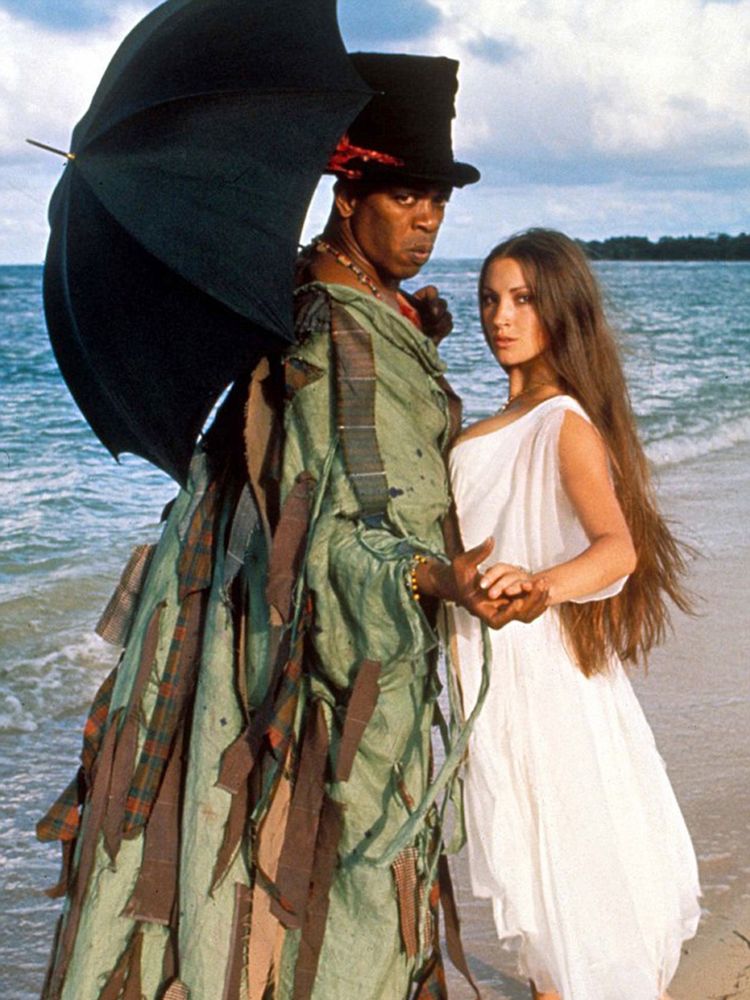 Baron Samedi poses with Solitaire on the beach 