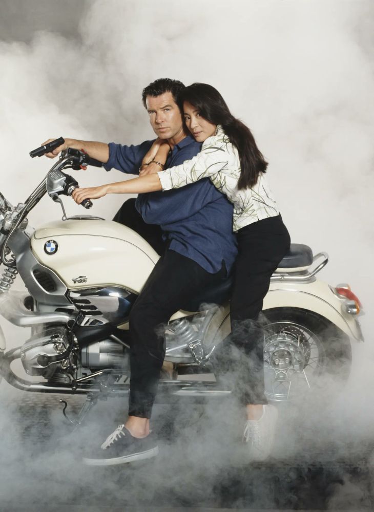 Michelle and Pierce pose on a motorbike in a promo shoot for TND