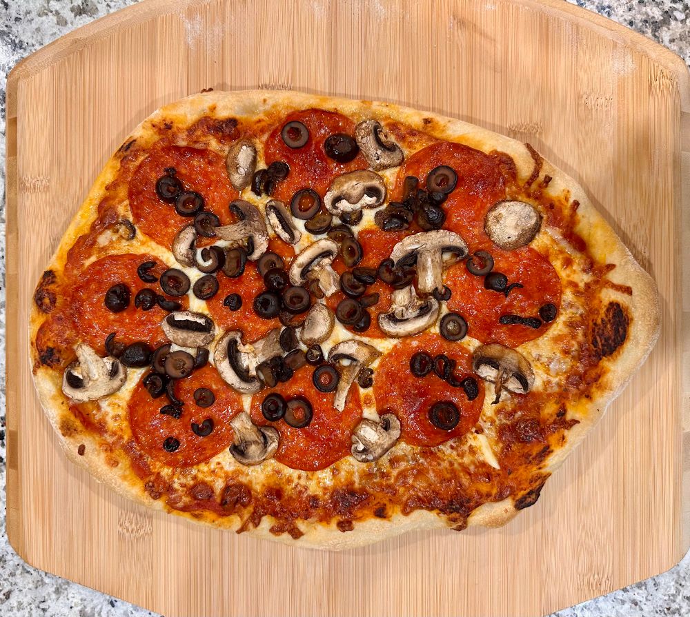 Homemade pepperoni, mushroom, and black olives pizza 