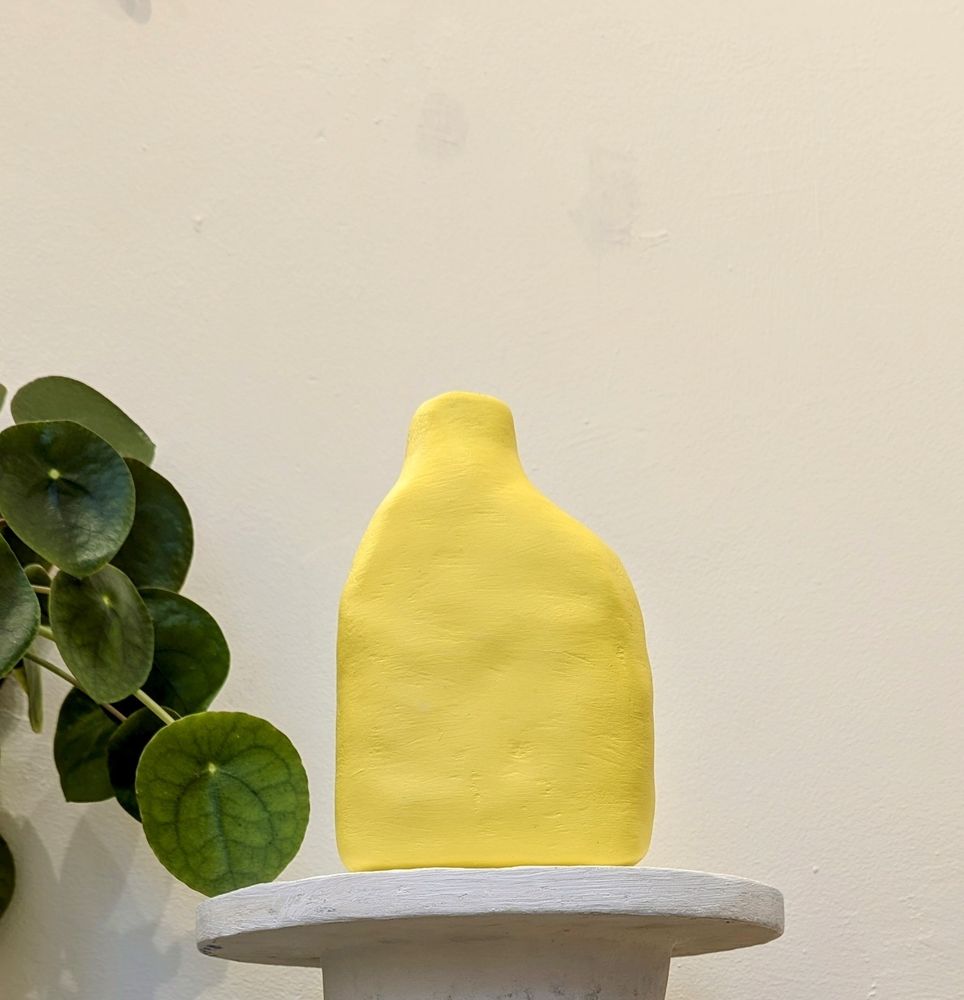 Bright lemon vessel, inspired by antiquity, made from scrap paper and plaster with a water tight reclaimed plaster lining.