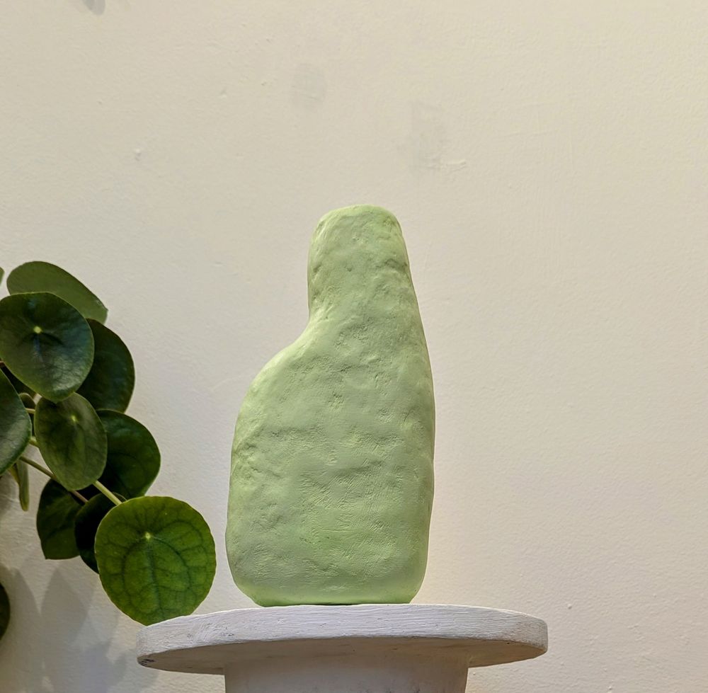 Pale lime green vessel, inspired by antiquity, made from scrap paper and plaster with a water tight reclaimed plaster lining.