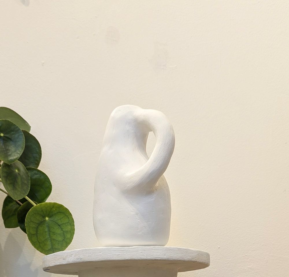 Soft white vessel, inspired by antiquity, made from scrap paper and plaster with a water tight reclaimed plaster lining.