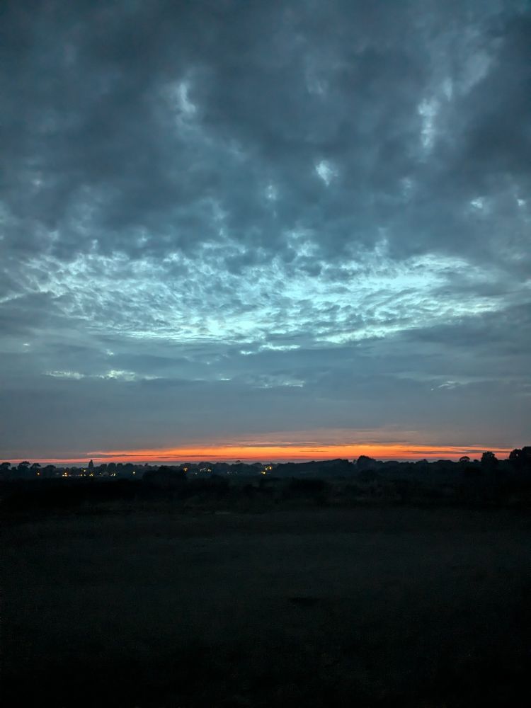 A silver blue and glowing orange sunset