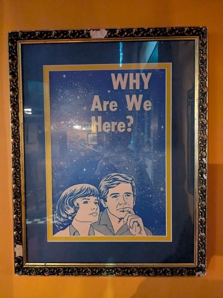 An old poster in a pub asking why are we here?