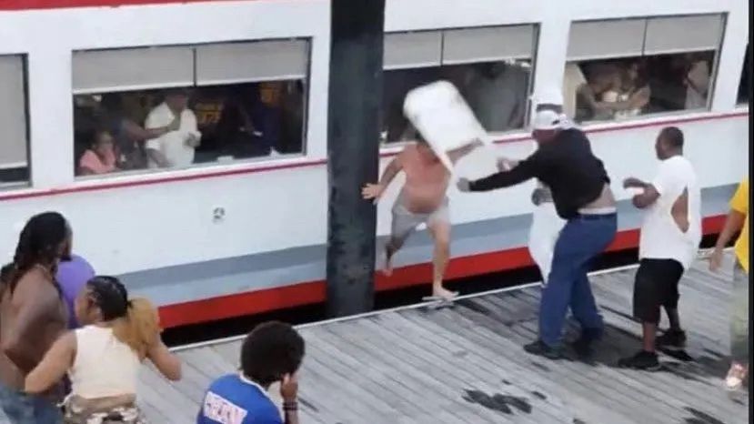 Moment from the Alabama riverboat brawl where a shirtless white dude gets absolutely recked by a Black dude with a folding chair.