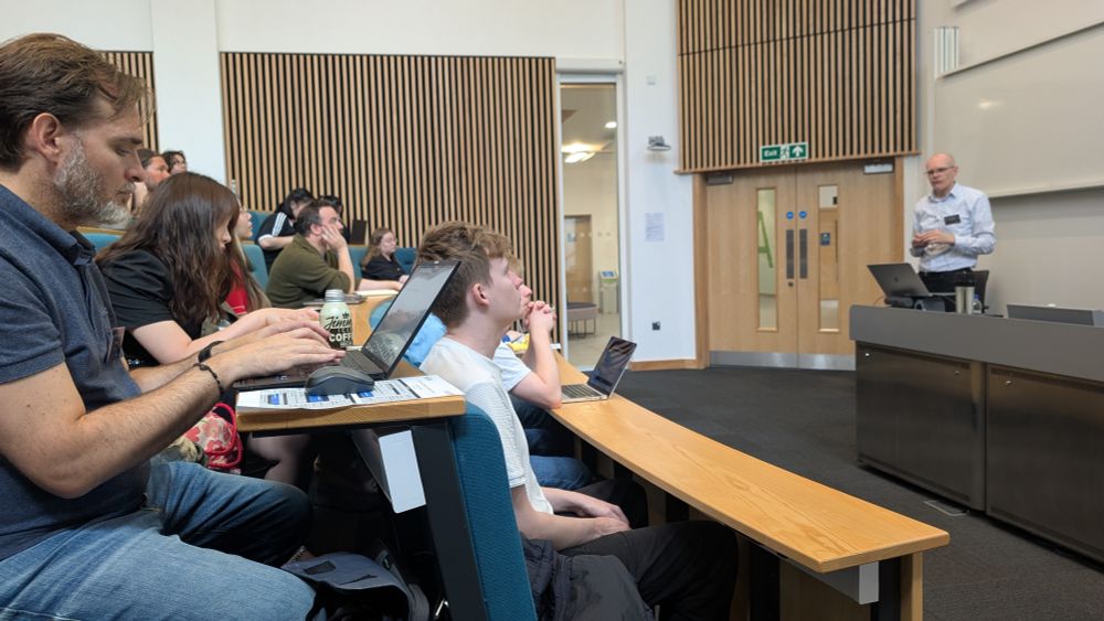 Steve Hodges gives a talk in a crowded lecture theatre at Lancaster University as part of the Device Prototyping Summer School.