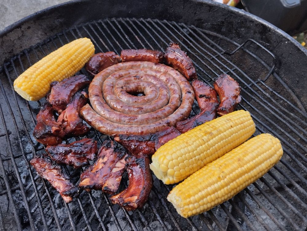 Bbq meat, sticky bbq ribs and sausage, yellow corn on bbq. 