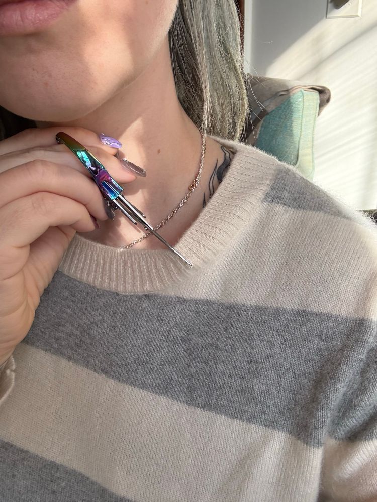 Dare me to cut the neck? (I did after this photo). Holding part of the neck line between a pair of scissors.