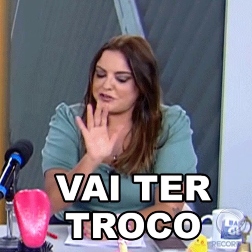 a woman sitting at a desk with the words vai ter troco on her face