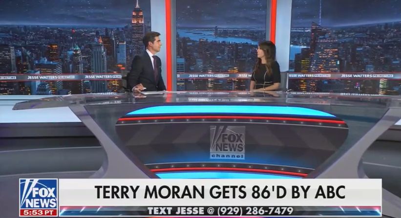 A screenshot from Fox News' Jesse Watters Primetime It's a wide shot of Jesse Watters and his guest sitting at some ugly ass, long ass desk The chyron reads 