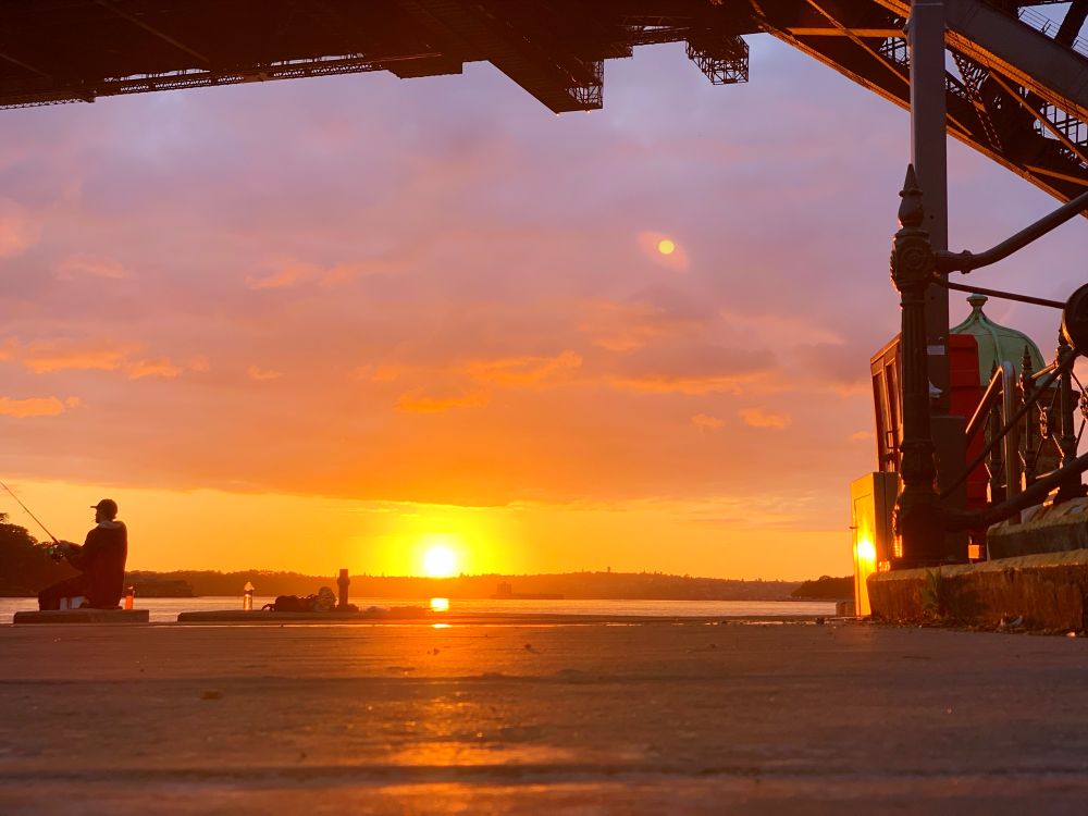 Sunsets on fishermen under the Sydney harbour bridge