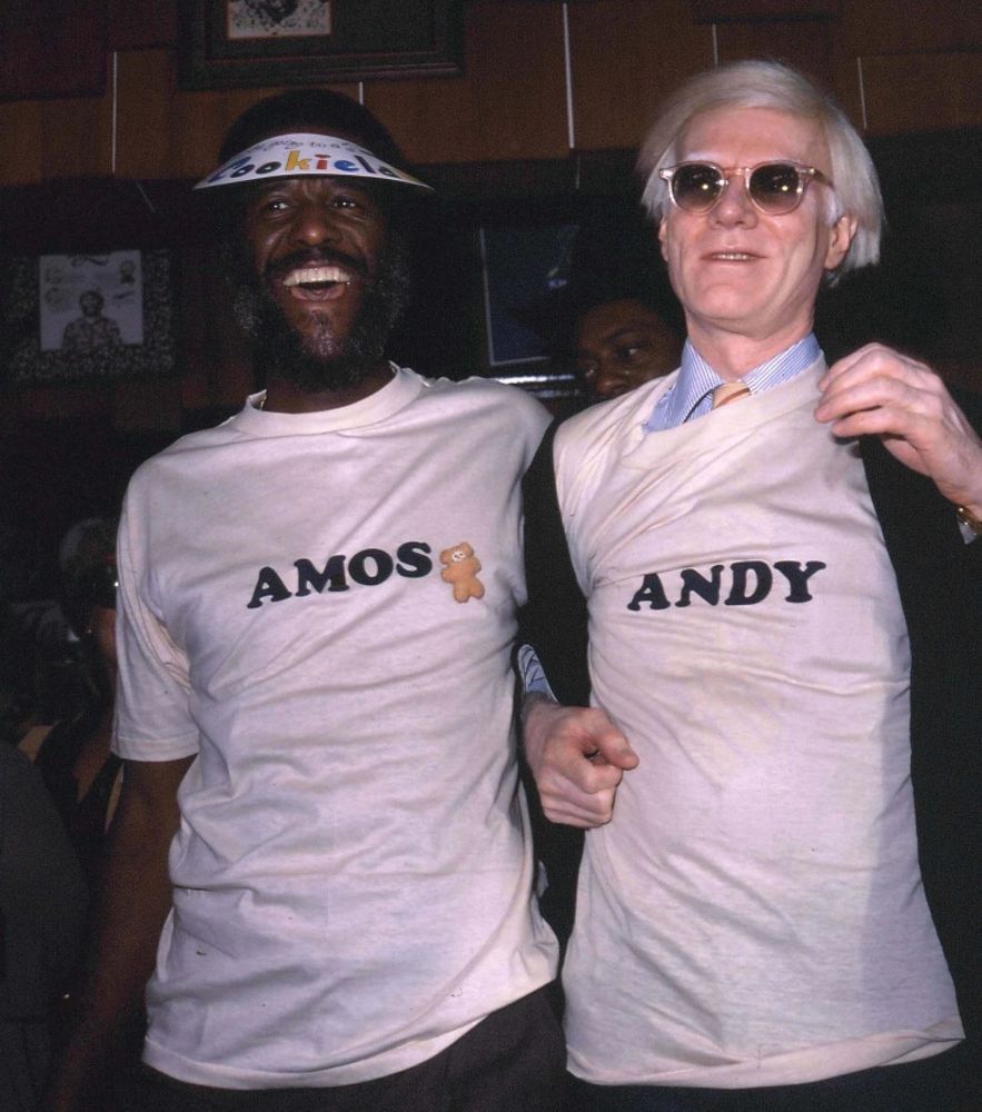 Famous Anus and Andy Warhol in white tee shirts that say Amos and Andy. 