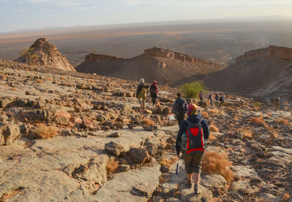 A group of palaeontologists making their way down the "Red Cliff", the Hamar Laghdad fossil site.