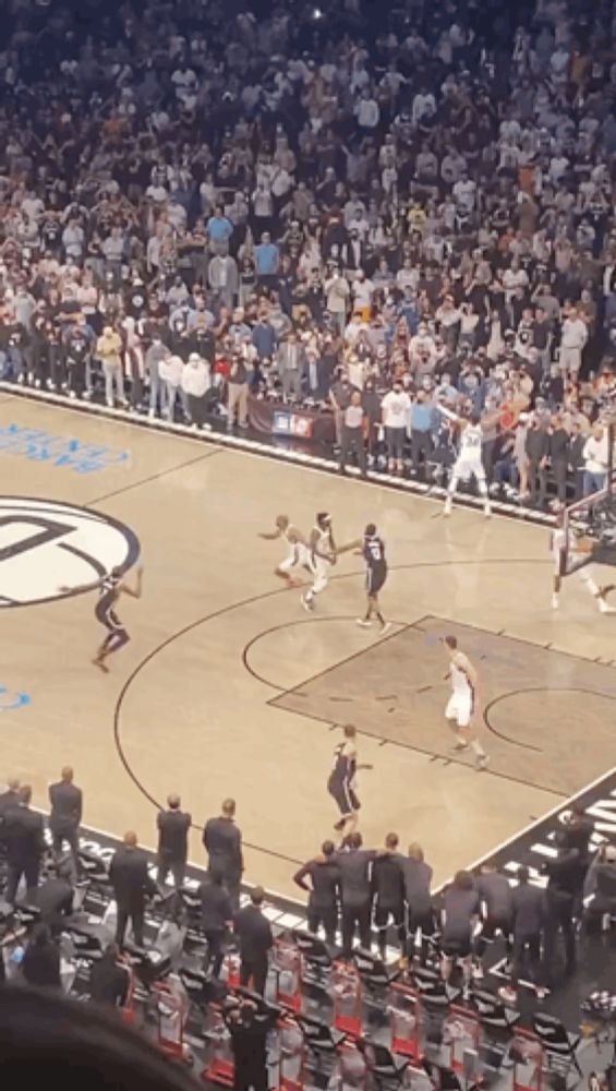 a basketball game is being played in front of a crowd with a player wearing number 20