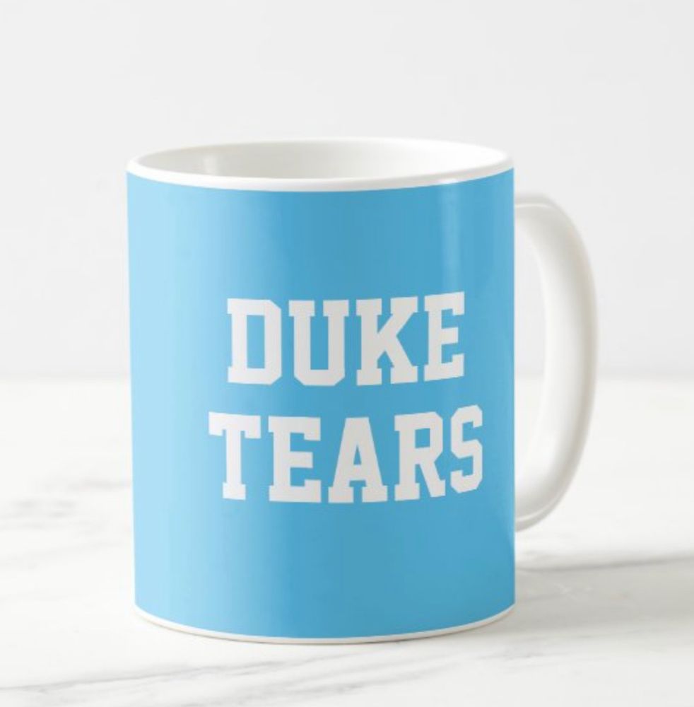 A Carolina blue mug with the words “Duke Tears” printed on the side in white block letters.