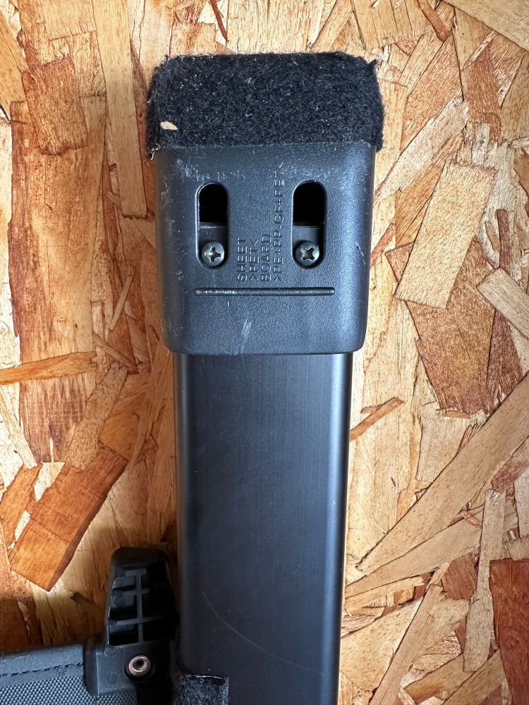 The end of a bar that goes inside a car, to mount a pull/out panel that covers the trunk cargo area. The placement of the screws and molding look like a sad face, and the expanded grippy part on the end looks like one of those big furry hats worn by Cossacks
