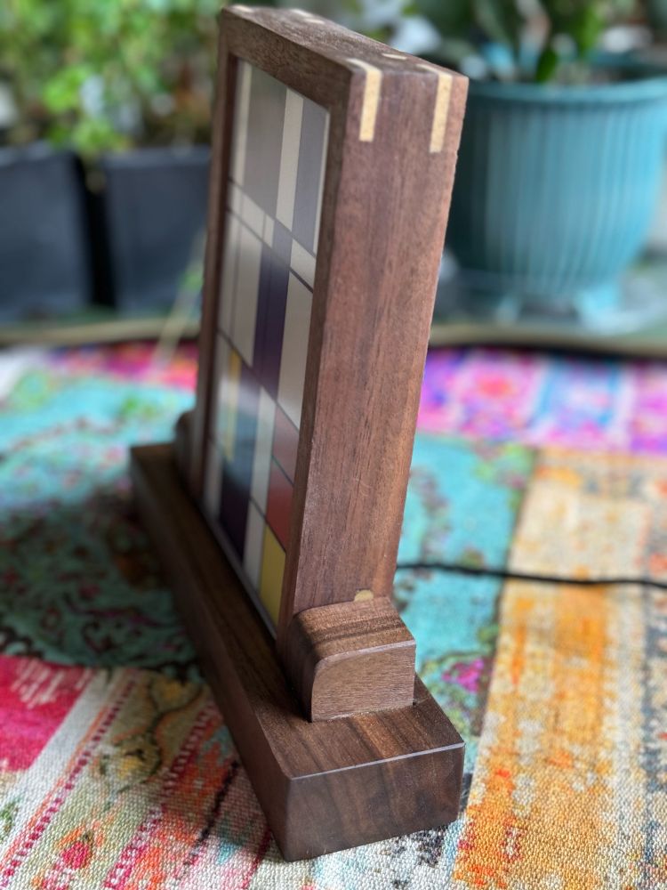 Side view of a custom walnut frame and base.