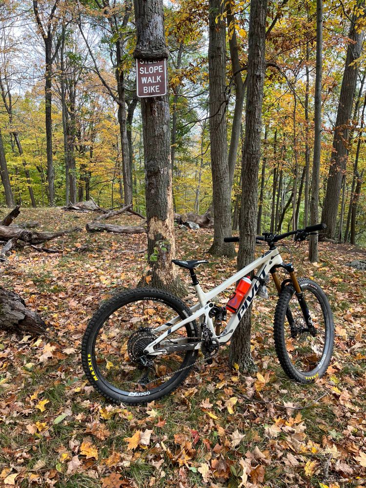 My bike in front of a sign that reads “Steep slope, walk bike”