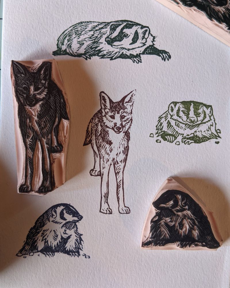 Small handmade stamps of coyote and several american badgers