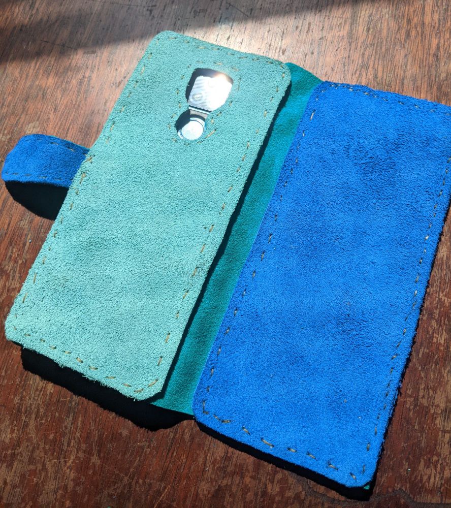 A colorful handsewn blue and teal leather phone case