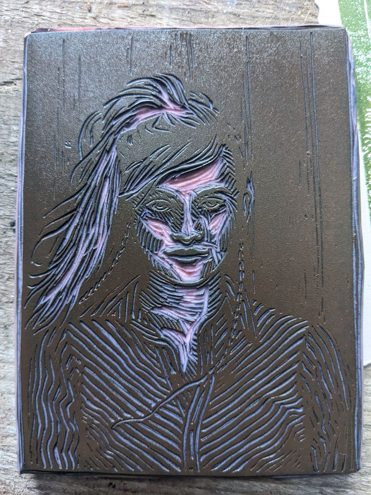 One of the blocks the portrait is printed from inked up. The light is hitting the eyes of the carved portrait, the effect is quite spooky.